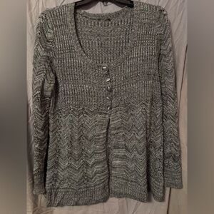 Sweater with five buttons. Open at the bottom. Unsure of size. Either 2-3X